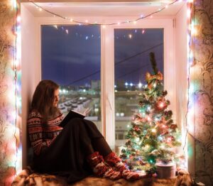 Young woman reading on Christmas