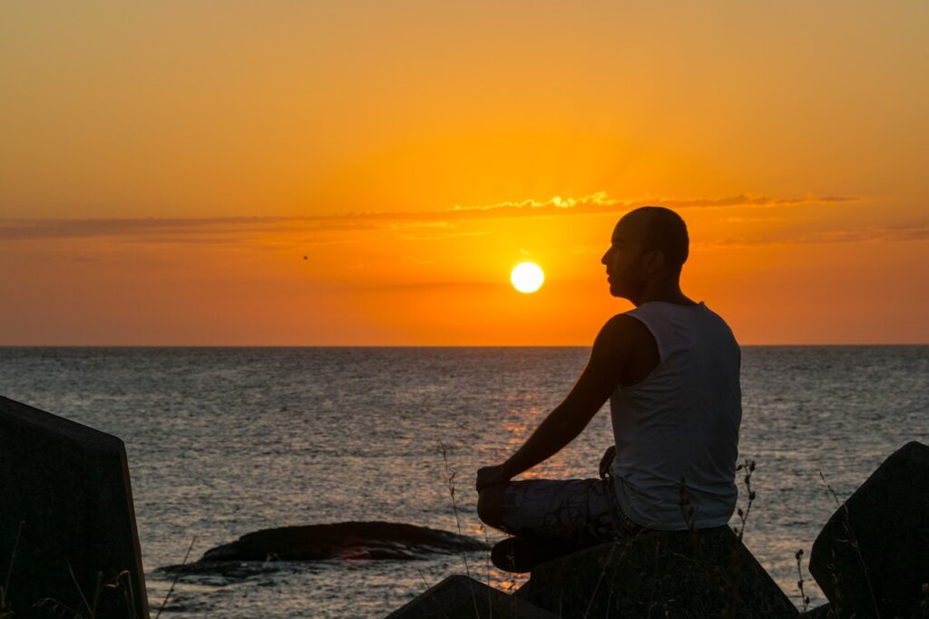 Mindfulness, man meditating in the beach