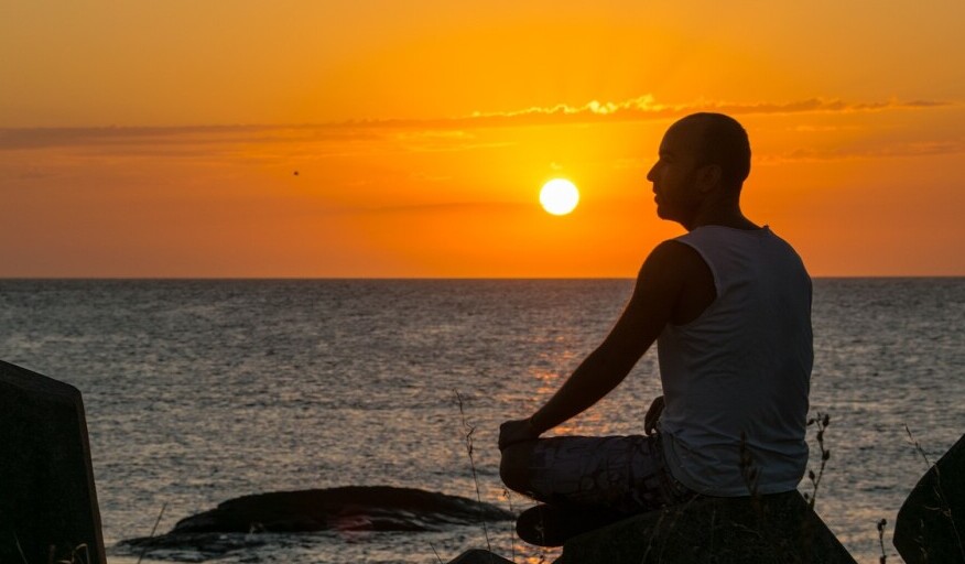 Mindfulness, Man meditating in the beach