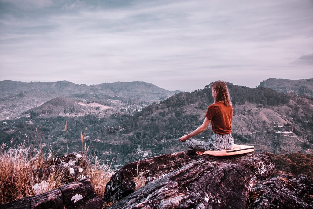 Woman Meditating in Hills