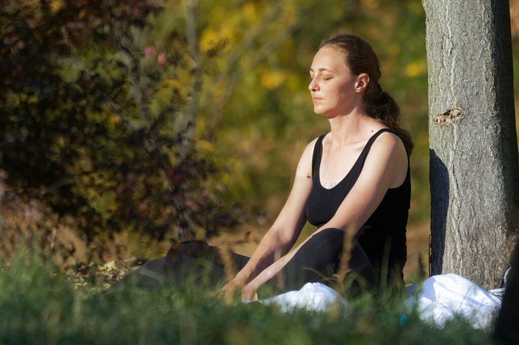 Woman Meditating In The Park