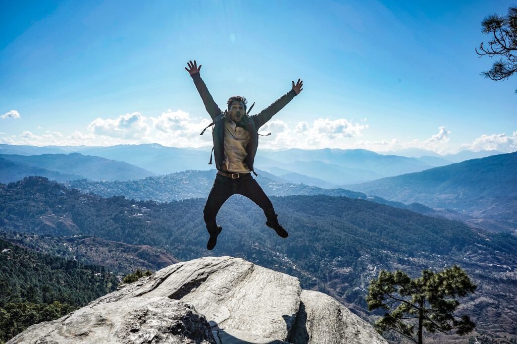 Man Happy Jumping on the Hill